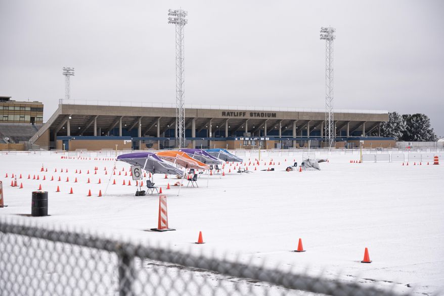 The mass vaccination clinic put on by Medical Center Hospital and the City of Odessa at Ratliff Stadium is seen covered in snow and ice Saturday, Feb. 13, 2021 in Midland, Texas. Subfreezing temperatures are expected in all of Texas, according to the National Weather Service, and snowfall totals of up to 8 inches (20 centimeters) are forecast in the Dallas area. Up to 2 inches (5 centimeters) could fall in the Houston area. (Eli Hartman/Odessa American via AP)