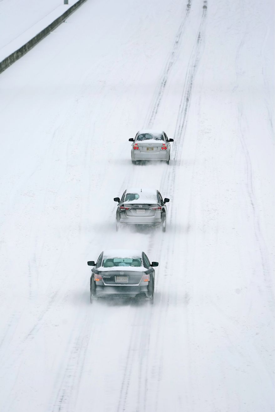 While the highway has several lanes, some drivers preferred to follow an established trail in Jackson, Mississippi. The National Weather Service forecasts temperatures barely hovering at 20 degrees. (ASSOCIATED PRESS PHOTOGRAPHS)