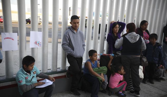 In this Sept. 13, 2019, file photo, Central American migrants wait to see if their number will be called to cross the border and apply for asylum in the United States, at the El Chaparral border crossing in Tijuana, Mexico. Thousands of people are waiting to claim asylum and more come each day, falsely believing they will be able to enter the U.S. now that former President Donald Trump is out of office. While President Joe Biden has taken some major steps in his first weeks in office to reverse Trump&#x27;s hardline immigration policies, his administration hasn&#x27;t lifted some of the most significant barriers to asylum-seekers. (AP Photo/Emilio Espejel, File)