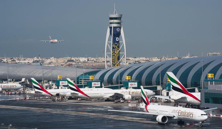 FILE - In this Dec. 11, 2019 file photo, an Emirates jetliner comes in for landing at Dubai International Airport in Dubai, United Arab Emirates. The airport saw the coronavirus pandemic push passenger traffic down by an unprecedented 70% in 2020, its CEO announced Monday, Feb. 15, 2021, even as the airport held onto its prized title as the world&#39;s busiest for international travel. (AP Photo/Jon Gambrell, File)