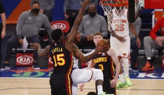 New York Knicks&#39; Elfrid Payton (6) goes to the basket against Atlanta Hawks&#39; Clint Capela (15), of Switzerland, during the first quarter of an NBA basketball game Monday, Feb. 15, 2021, in New York. (AP Photo/Jason DeCrow, Pool)