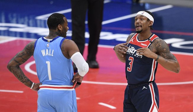 Houston Rockets guard John Wall (1) and Washington Wizards guard Bradley Beal (3) stand on the court during the first half of an NBA basketball game, Monday, Feb. 15, 2021, in Washington. (AP Photo/Nick Wass)
