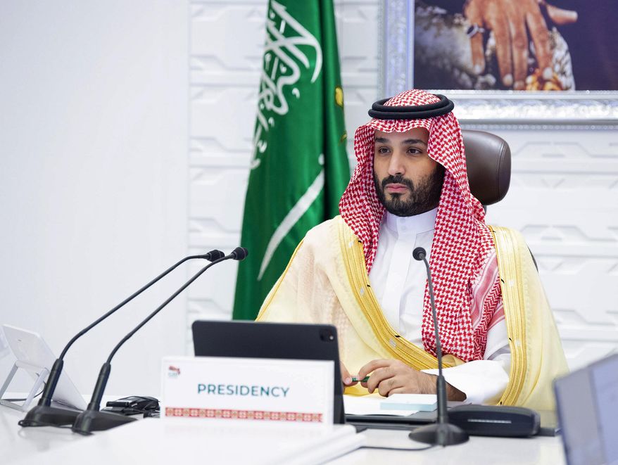 FILE - In this Nov. 22, 2020 file photo, Saudi Arabia's Crown Prince Mohammed bin Salman attends a virtual G-20 summit held over video conferencing, in Riyadh, Saudi Arabia. Saudi Arabia announced on Monday, Feb. 15, 2021, that it plans to stop signing contracts with foreign companies that don’t have their Mideast headquarters in the kingdom, state-run media reported, a bold move that could escalate business competition in the region. (Bandar Aljaloud/Saudi Royal Palace via AP, File)