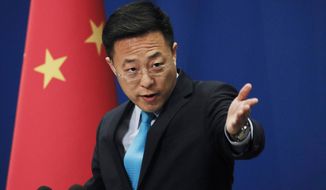 In this Monday, Feb. 24, 2020, file photo, Chinese Foreign Ministry spokesman Zhao Lijian speaks during a daily briefing at the Ministry of Foreign Affairs office in Beijing. (AP Photo/Andy Wong, File)