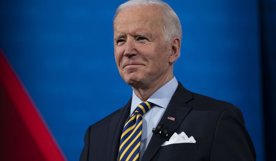 President Joe Biden talks with audience members as he waits for a commercial break to end during a televised town hall event at Pabst Theater, Tuesday, Feb. 16, 2021, in Milwaukee. (AP Photo/Evan Vucci)