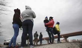 Honduran and Cuban migrants are questioned by Mexican migration authorities after attempting to cross the Rio Bravo on the border with the U.S., in Ciudad Juarez, Chihuahua state, Mexico, Tuesday, Feb. 16, 2021. The number of people apprehended at the U.S.-Mexico border has increased since Jan. with migrant families crossing from Ciudad Juarez and turning themselves over to Border Patrol. (AP Photo/Christian Chavez) **FILE**