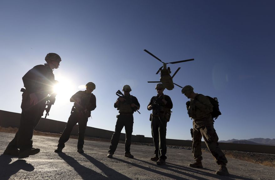 American soldiers wait on the tarmac in Logar province, Afghanistan. (AP Photo/Rahmat Gul, File)