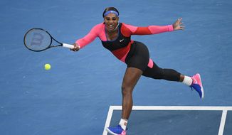 United States&#39; Serena Williams hits a forehand return to Romania&#39;s Simona Halep during their quarterfinal match at the Australian Open tennis championship in Melbourne, Australia, Tuesday, Feb. 16, 2021.(AP Photo/Andy Brownbill)