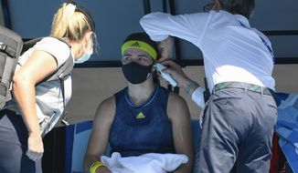 Karolina Muchova of the Czech Republic receives medical treatment during her quarterfinal against Australia&#39;s Ash Barty at the Australian Open tennis championship in Melbourne, Australia, Wednesday, Feb. 17, 2021.(AP Photo/Andy Brownbill)