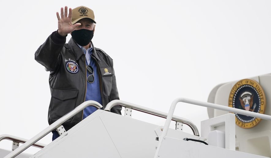 President Joe Biden boards Air Force One at Hagerstown Regional Airport, Monday, Feb. 15, 2021, in Hagerstown, Md., after spending the weekend with first lady Jill Biden and family at Camp David. (AP Photo/Evan Vucci)