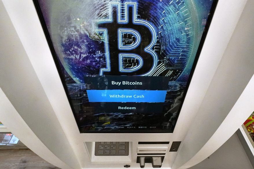 The Bitcoin logo appears on the display screen of a crypto currency ATM at the Smoker's Choice store, Tuesday, Feb. 9, 2021, in Salem, N.H. The price of Bitcoin has soared over the past months. (AP Photo/Charles Krupa)