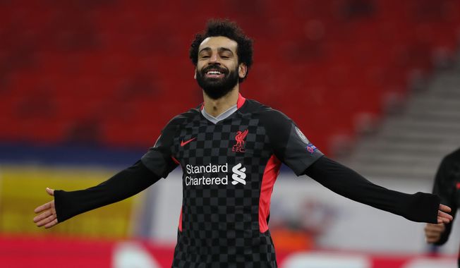Liverpool&#x27;s Mohamed Salah celebrates after scoring his side&#x27;s first goal during the Champions League round of 16, first leg, soccer match between RB Leipzig and Liverpool at the Ferenc Puskas stadium in Budapest, Hungary, Tuesday, Feb. 16, 2021. (AP Photo/Laszlo Balogh)