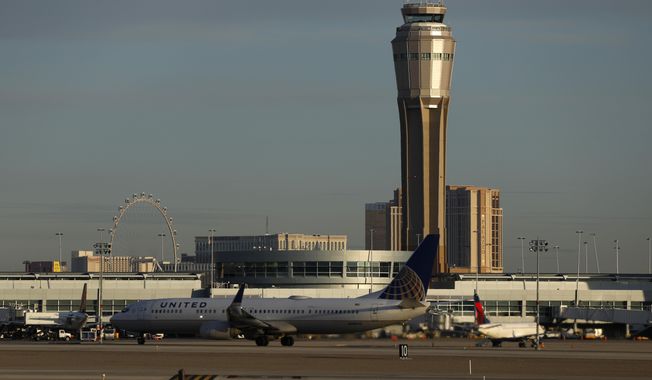 FILE - In this March 19, 2020, file photo a plane takes off at McCarran International airport, in Las Vegas. A county board voted unanimously Tuesday, Feb. 16, 2021, to rename busy McCarran International Airport in Las Vegas after former U.S. Sen. Harry Reid of Nevada. (AP Photo/John Locher, File)