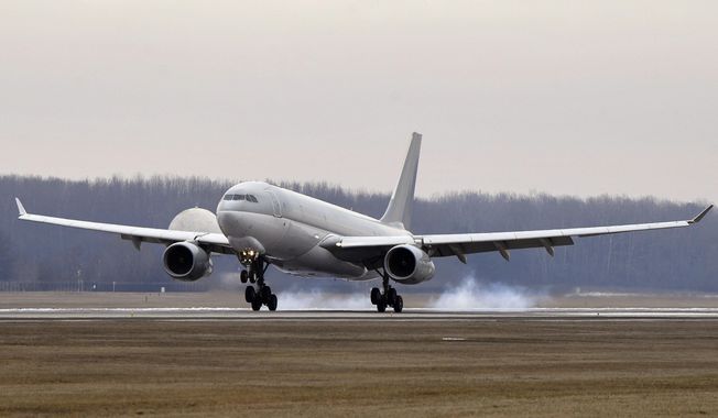 A Hungarian Airbus 330 plane transporting the first batch of the vaccine against the new coronavirus produced by Sinopharm of China to Hungary lands at Budapest Liszt Ferenc International Airport in Budapest, Hungary, Tuesday, Feb. 16, 2021. The vaccine will not be used without its examination and approval by the National Public Health Center. (Zoltan Mathe/MTI via AP)