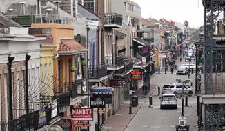 In this file photo, Bourbon Street, which is normally packed with revelers, is seen deserted during Mardi Gras in the French Quarter of New Orleans, Tuesday, Feb. 16, 2021.  (AP Photo/Gerald Herbert)  **FILE**