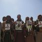 Houthis rebels hold posters of their relatives during a funeral procession for Houthis who who were killed in recent fighting with forces of Yemen&#39;s Saudi-backed internationally recognized government, in Sanaa, Yemen, Tuesday, Feb. 16, 2021. (AP Photo/Hani Mohammed)