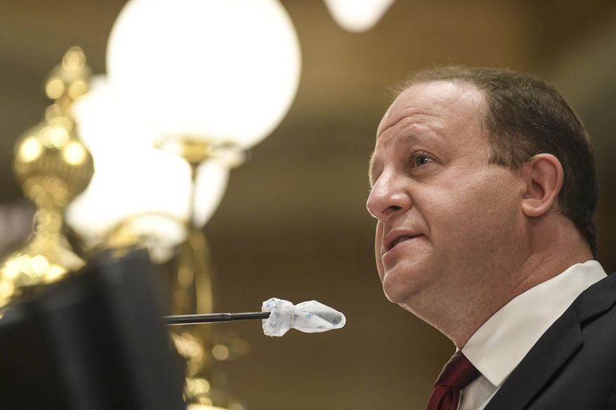 Gov. Jared Polis delivers his state of the state address in front of the House of Representatives at the Colorado State Capitol Building in Denver on Wednesday, Feb. 17, 2021. (AAron Ontiveroz/The Denver Post via AP, Pool)