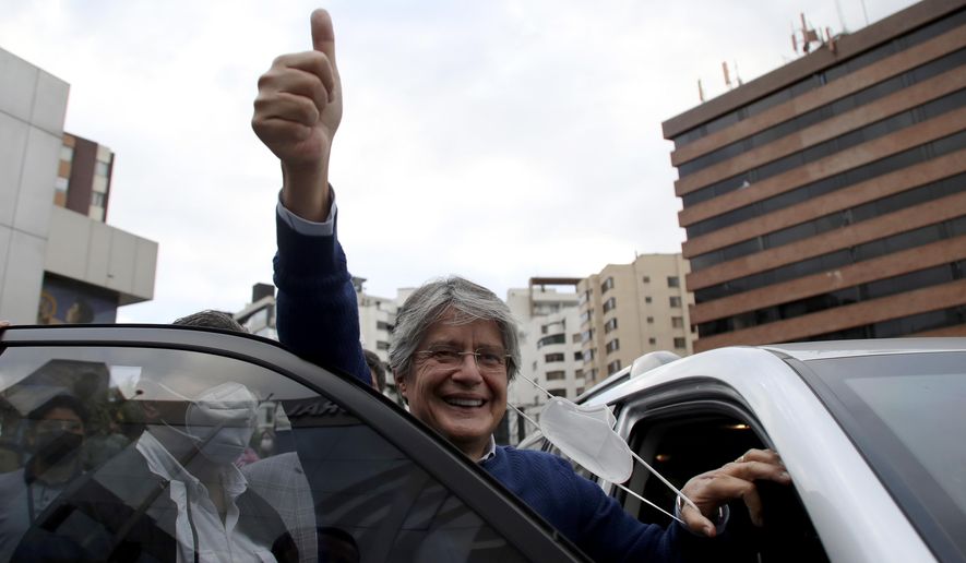 Presidential candidate Guillermo Lasso, representing the Creating Opportunities party or CREO, flashes a thumbs up after attending an event with rival Yaku Perez, of the Pachakutik political party, in which both are asking for a ballot recount of Sunday&#x27;s election, in Quito, Ecuador, Friday, Feb. 12, 2021. It remains undecided which of the two has the votes to advance to the run-off race in April to face frontrunner Andres Arauz. (AP Photo/Dolores Ochoa)