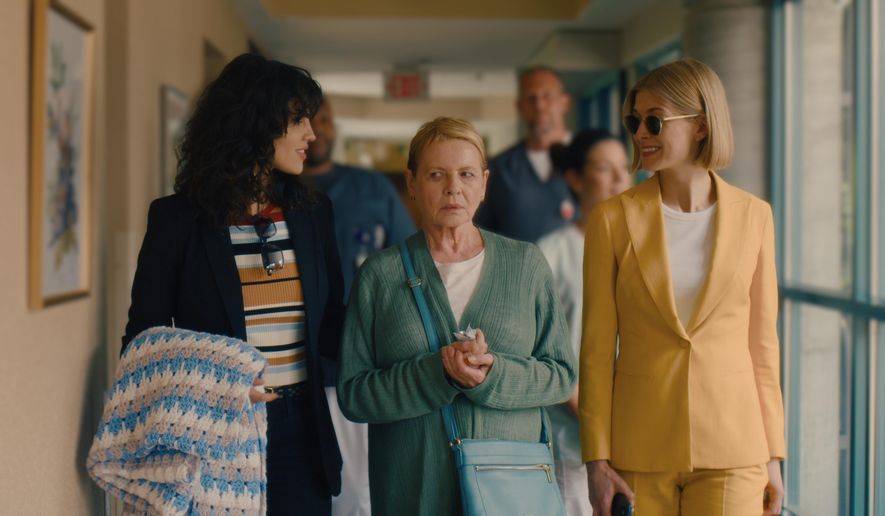 This image released by Netflix shows, from left, Eiza Gonzalez, Dianne Wiest and Rosamund Pike in a scene from "I Care A Lot." (Seacia Pavao/Netflix via AP)