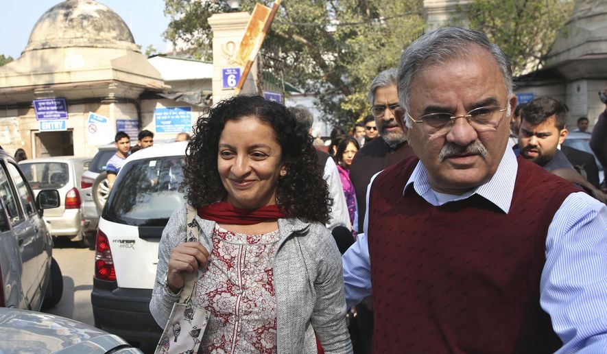 FILE - In this Monday, Feb. 25, 2019, file photo, Indian journalist Priya Ramani, left, smiles as she leaves Patiala House Court in New Delhi, India. A New Delhi court on Wednesday, Feb. 17, 2021, acquitted Ramani of criminal defamation after she accused a former editor-turned-politician and junior external affairs minister of sexual harassment. M.J. Akbar, now 70,  filed a case against Ramani in Oct. 2018, denying the allegations as “false, baseless and wild.” (AP Photo/File)