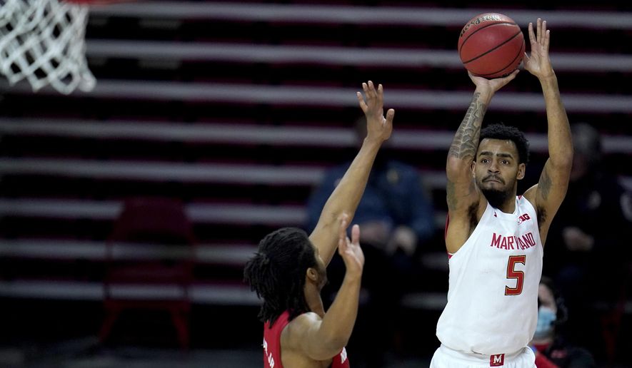 Maryland guard Eric Ayala (5) shoots against Nebraska forward Derrick Walker (13) during the second half of an NCAA college basketball game, Wednesday, Feb. 17, 2021, in College Park, Md. (AP Photo/Julio Cortez)