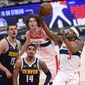 Washington Wizards guard Bradley Beal (3) goes to the basket against Denver Nuggets center Nikola Jokic (15) and guard Gary Harris (14) during the first half of an NBA basketball game, Wednesday, Feb. 17, 2021, in Washington. (AP Photo/Nick Wass)