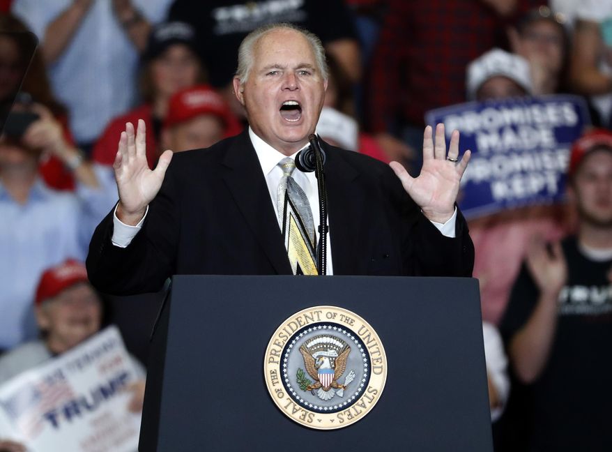 FILE - This Nov. 5, 2018 file photo shows radio personality Rush Limbaugh introducing President Donald Trump at the start of a campaign rally in Cape Girardeau, Mo. Limbaugh, the talk radio host who became the voice of American conservatism, has died.  (AP Photo/Jeff Roberson, File)