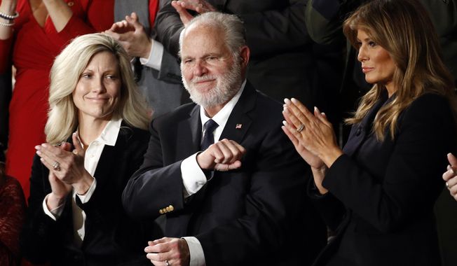 In this Feb. 4, 2020, file photo, Rush Limbaugh reacts as first lady Melania Trump, and his wife Kathryn, applaud, as President Donald Trump delivers his State of the Union address to a joint session of Congress on Capitol Hill in Washington. Limbaugh, the talk radio host who became the voice of American conservatism, died on Feb. 17, 2021, of lung cancer. (AP Photo/Patrick Semansky, File)