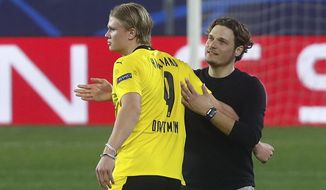 Dortmund&#39;s Erling Haaland, left is congratulated by Dortmund&#39;s head coach Edin Terzic at the end of the Champions League, round of 16, first leg soccer match between Sevilla and Borussia Dortmund at the Ramon Sanchez Pizjuan stadium in Seville, Spain, Wednesday, Feb. 17, 2021. (AP Photo/Angel Fernandez)