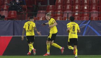 Dortmund&#39;s Erling Haaland, centre, celebrates after scoring his side&#39;s second goal during the Champions League, round of 16, first leg soccer match between Sevilla and Borussia Dortmund at the Ramon Sanchez Pizjuan stadium in Seville, Spain, Wednesday, Feb. 17, 2021. (AP Photo/Angel Fernandez)