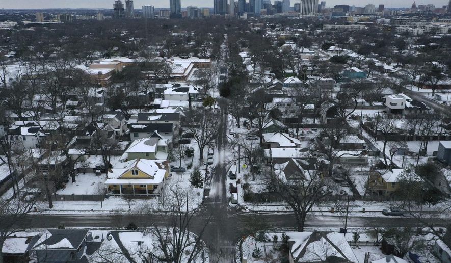 Snow and ice grips a neighborhood in East Austin on Tuesday, Feb. 16, 2021. Day six of the statewide freeze and still millions of Texans are without power. (Bronte Wittpenn /Austin American-Statesman via AP)