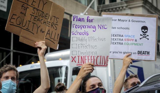 In this Aug. 3, 2020, file photo, a coalition of teachers, students, and families protest during a rally called National Day of Resistance Against Unsafe School Reopening Opening, in New York.  (AP Photo/Bebeto Matthews, File)
