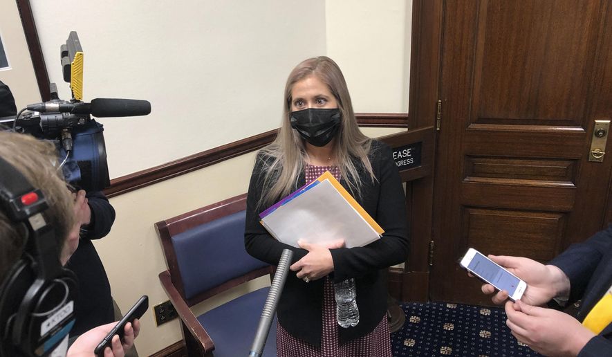 Alaska state Rep. Sara Rasmussen speaks to reporters after a House floor session on Thursday, Feb. 18, 2021, in Juneau, Alaska. Rasmussen has said she is not participating in either the bipartisan coalition led by Republican Speaker Louise Stutes or an 18-member Republican caucus but said she was able to negotiate a seat as member of the House Finance Committee to make sure her constituents' needs are heard. (AP Photo/Becky Bohrer)