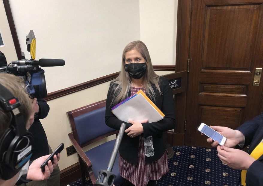 Alaska state Rep. Sara Rasmussen speaks to reporters after a House floor session on Thursday, Feb. 18, 2021, in Juneau, Alaska. Rasmussen has said she is not participating in either the bipartisan coalition led by Republican Speaker Louise Stutes or an 18-member Republican caucus but said she was able to negotiate a seat as member of the House Finance Committee to make sure her constituents' needs are heard. (AP Photo/Becky Bohrer)