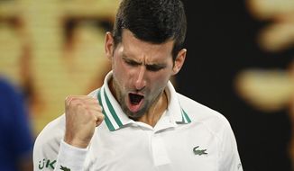 Serbia&#39;s Novak Djokovic celebrates after defeating Russia&#39;s Aslan Karatsev in their semifinal match at the Australian Open tennis championship in Melbourne, Australia, Thursday, Feb. 18, 2021..(AP Photo/Andy Brownbill)