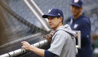 FILE - Milwaukee Brewers manager Craig Counsell watches his players take batting practice before a baseball game against the Washington Nationals in Washington, in this Monday, Sept. 30, 2019, file photo. Brewers manager Craig Counsell has a pretty simple formula for boosting a lineup that struggled throughout the abbreviated 2020 season. His hitters just need to produce the way they typically have throughout their careers. (AP Photo/Patrick Semansky, File)