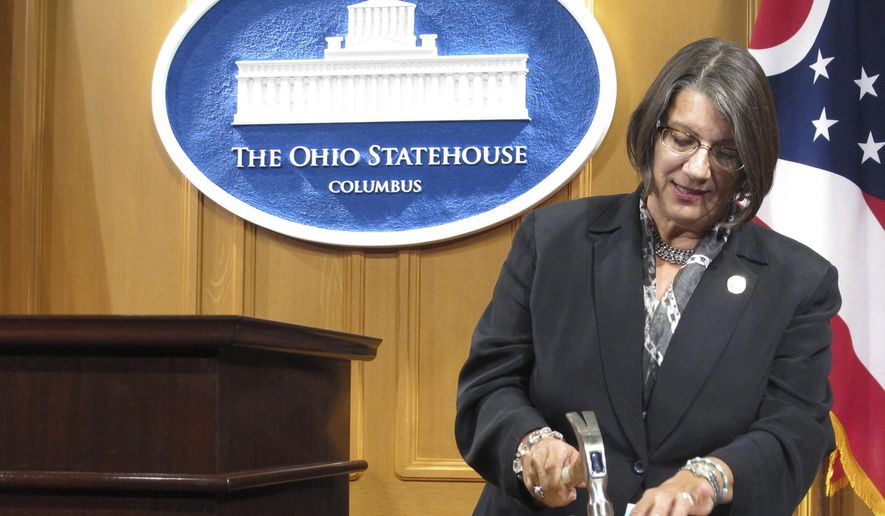 FILE - In this Sept. 17, 2015, file photo, Ohio state Rep. Nickie Antonio, a Democrat from Lakewood in suburban Cleveland, demonstrates tamper-resistant pain pills during a news conference in Columbus, Ohio. Ohio death penalty opponents are announcing a new effort to end capital punishment that includes several GOP supporters of a ban. Antonio, a longtime death penalty opponent, was joined at a news conference Thursday, Feb. 18, 2021, by three Republican senators who support ending capital punishment.  (AP Photo/Andrew Welsh-Huggins, File)
