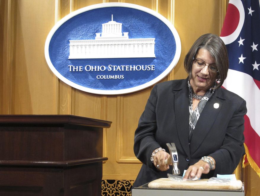 FILE - In this Sept. 17, 2015, file photo, Ohio state Rep. Nickie Antonio, a Democrat from Lakewood in suburban Cleveland, demonstrates tamper-resistant pain pills during a news conference in Columbus, Ohio. Ohio death penalty opponents are announcing a new effort to end capital punishment that includes several GOP supporters of a ban. Antonio, a longtime death penalty opponent, was joined at a news conference Thursday, Feb. 18, 2021, by three Republican senators who support ending capital punishment. (AP Photo/Andrew Welsh-Huggins, File)
