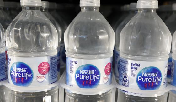 FILE - In this Sept. 21, 2018, file photo, is a closeup of pint bottles of purified water, Pure Life, manufactured by Nestle, on sale in a Ridgeland, Miss., convenience store. Global food giant Nestle is selling its North American bottled-water brands for $4.3 billion to a pair of private-equity firms that hope to reinvigorate sales. Brands including Poland Spring, Deer Park, Arrowhead and Pure Life will be sold to a subsidiary of One Rock Capital Partners in partnership with Metropoulos &amp;amp; Co. (AP Photo/Rogelio V. Solis, File)