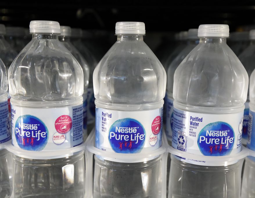FILE - In this Sept. 21, 2018, file photo, is a closeup of pint bottles of purified water, Pure Life, manufactured by Nestle, on sale in a Ridgeland, Miss., convenience store. Global food giant Nestle is selling its North American bottled-water brands for $4.3 billion to a pair of private-equity firms that hope to reinvigorate sales. Brands including Poland Spring, Deer Park, Arrowhead and Pure Life will be sold to a subsidiary of One Rock Capital Partners in partnership with Metropoulos &amp;amp; Co. (AP Photo/Rogelio V. Solis, File)