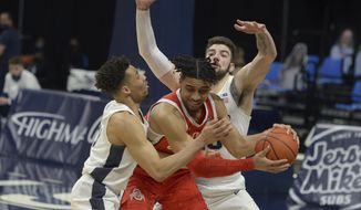 In the final minute of play, Ohio State&#x27;s Justice Sueing, center, takes an inbound pass and is pressured by Penn State&#x27;s Myreon Jones, eft, and Trent Buttrick, right, during the second half of an NCAA college basketball game, Thursday, Feb. 18, 2021, in State College, Pa. (AP Photo/Gary M. Baranec)