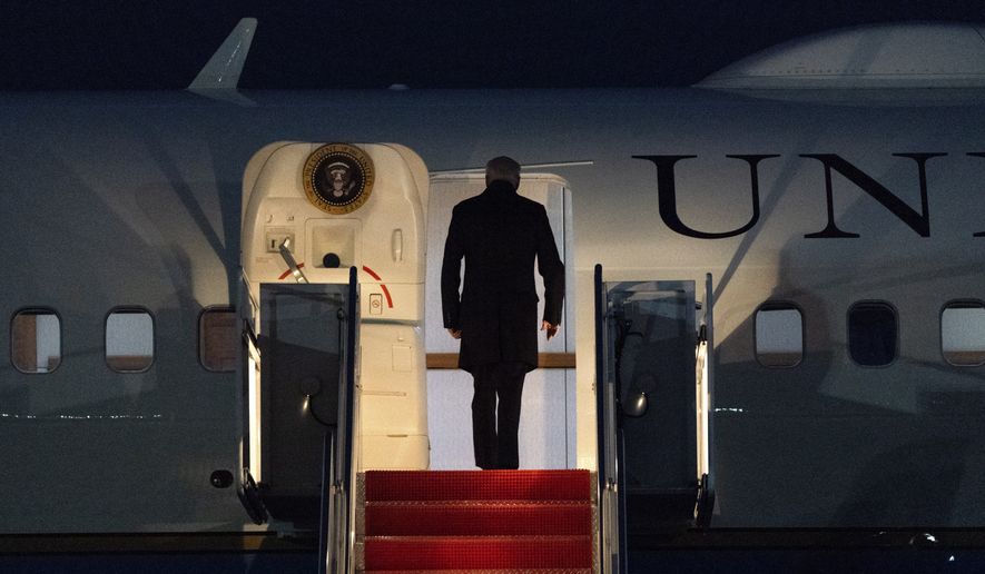 President Joe Biden boards Air Force One, at Andrews Air Force Base, Md., Friday, Feb. 12, 2021, en route to Camp David. (AP Photo/Jacquelyn Martin)
