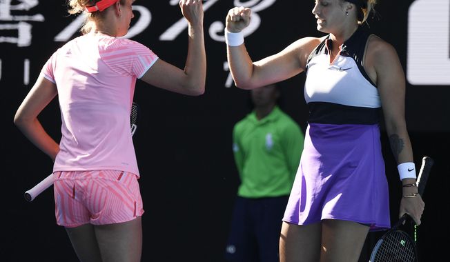 Belgium&#x27;s Elise Mertens, left, and Aryna Sabalenka of Belarus gesture as they play against Barbora Krejcikova and Katerina Siniakova of the Czech Republic during the women&#x27;s doubles final at the Australian Open tennis championship in Melbourne, Australia, Friday, Feb. 19, 2021.(AP Photo/Andy Brownbill)