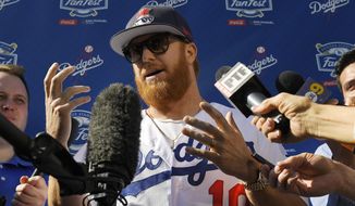 FILE - Los Angeles Dodgers&#39; Justin Turner is interviewed by reporters during Dodger Stadium FanFest in Los Angeles, in this Saturday, Jan. 25, 2020, file photo. Justin Turner&#39;s extended flirtation with free agency ended where it began — with the Los Angeles Dodgers. Along the way, the third baseman had doubts about whether he would return to his hometown team and wondered if his mask-less appearance on the field to celebrate its World Series championship would hurt him. (AP Photo/Mark J. Terrill, File)
