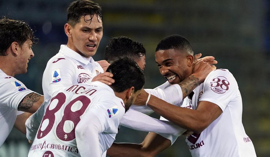 Torino&#39;s Gleison Bremer, right, celebrates with teammates after scoring a goal during a Serie A soccer match between Cagliari and Torino, in Cagliari’s Sardegna Arena stadium, Italy, Friday, Feb. 19, 2021. (Alessandro Tocco/LaPresse via AP)