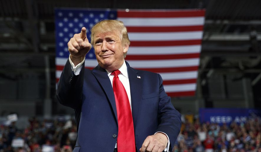 In this Wednesday, July 17, 2019, file photo, President Donald Trump gestures to the crowd as he arrives to speak at a campaign rally at Williams Arena in Greenville, N.C.  (AP Photo/Carolyn Kaster, File)  ** FILE **