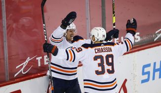 Edmonton Oilers&#39; Gaetan Haas, left, celebrates his goal with teammate Alex Chiasson (39) against the Calgary Flames during the second period of an NHL hockey game, Friday, Feb. 19, 2021 in Calgary, Alberta. (Todd Korol/The Canadian Press via AP)