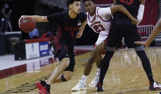 San Diego State&#39;s Trey Pulliam looks to drive past Fresno State&#39;s Leo Colimerio during the second half of an NCAA college basketball game in Fresno, Calif., Thursday, Feb. 18, 2021. (AP Photo/Gary Kazanjian)
