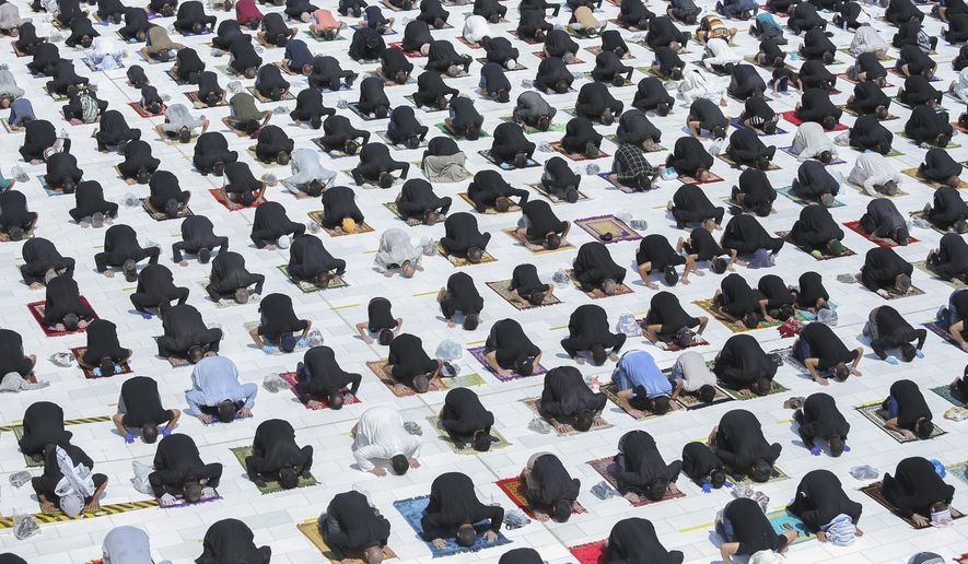 File - In this Friday, Sept. 11, 2020 file photo, Shiites attend a prayer or the first time in months since the restrictions were imposed to prevent the spread of the coronavirus at a mosque in Kufa, Iraq. (AP Photo/Anmar Khalil, File)