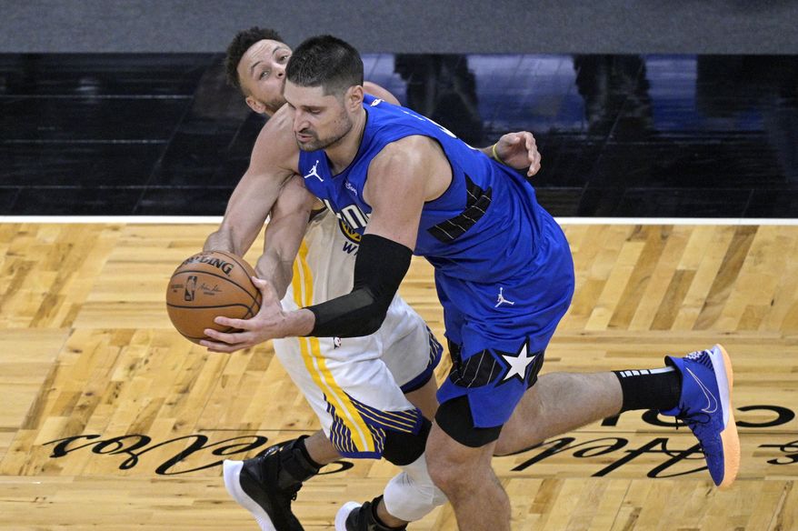 Orlando Magic center Nikola Vucevic, right, is fouled by Golden State Warriors guard Stephen Curry (30) during the second half of an NBA basketball game, Friday, Feb. 19, 2021, in Orlando, Fla. (AP Photo/Phelan M. Ebenhack)
